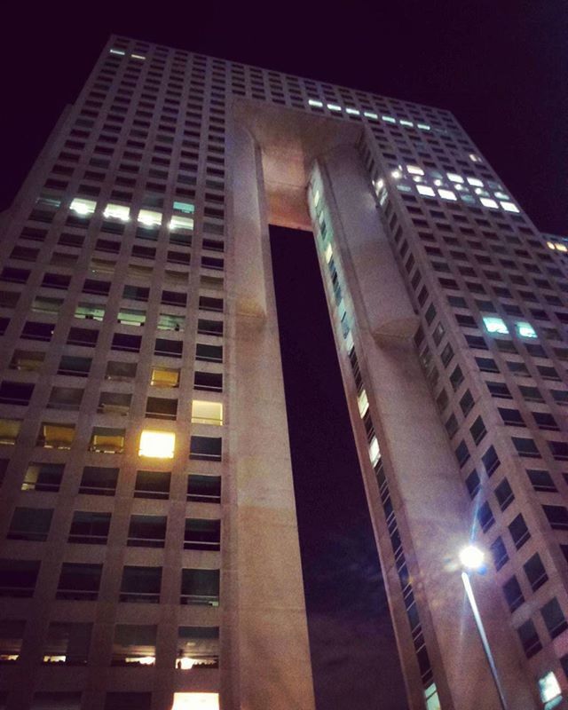 low angle view, architecture, built structure, building exterior, illuminated, night, building, city, modern, tall - high, office building, tower, sky, window, skyscraper, lighting equipment, no people, outdoors, street light, glass - material