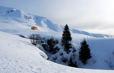 Scenic view of snow covered mountains against sky