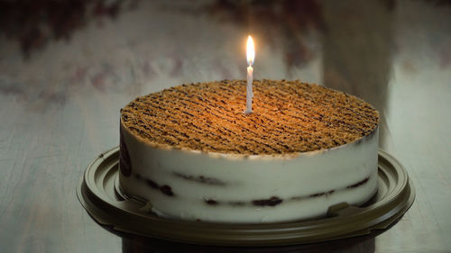 Birthday cake with colorful burning candle in dark. birthday cake with candle for any birthday.
