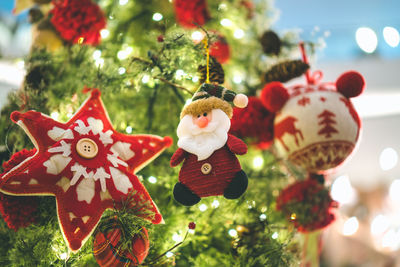 Close-up of christmas decorations hanging on tree
