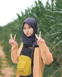 Portrait of smiling young woman standing outdoors