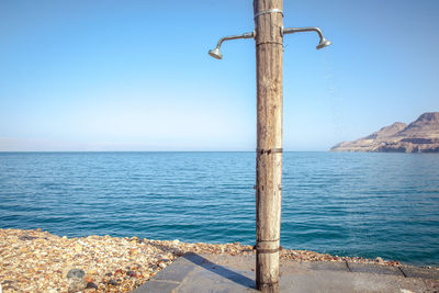 Scenic view of sea against clear blue sky