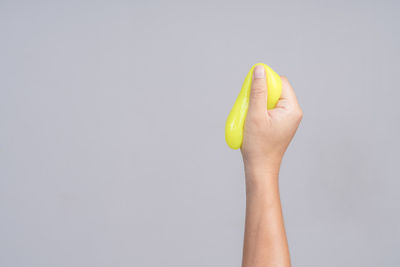 Midsection of person holding apple against white background