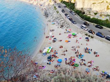 Aerial view of crowd at sandy beach