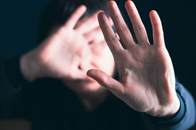 Close-up of human hand against black background