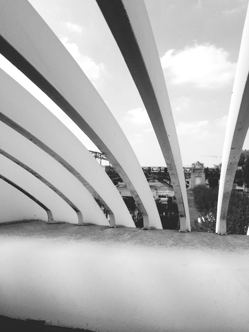 architecture, sky, built structure, transportation, glass - material, indoors, window, cloud - sky, modern, city, transparent, cloud, travel, day, bridge - man made structure, building exterior, connection, mode of transport, public transportation, reflection