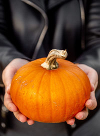Close-up of hand holding pumpkin