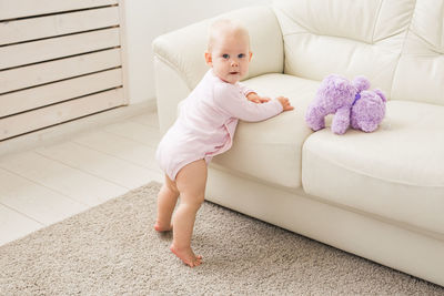 Portrait of baby girl standing at home