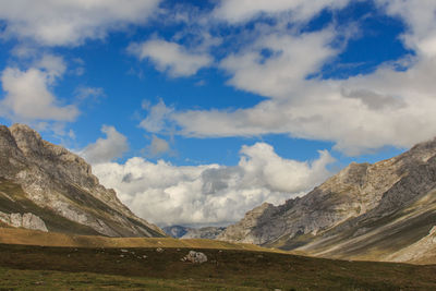 Scenic view of landscape and mountains against sky