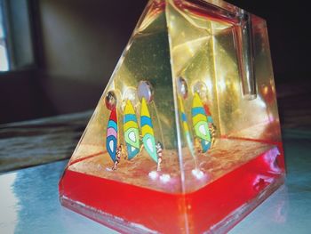 Close-up of multi colored glass on table