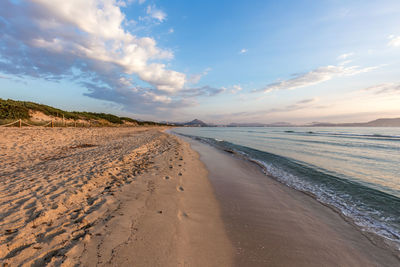 Scenic view of beach against sky during sunset