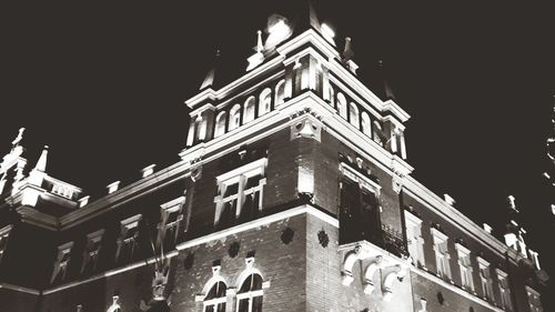 Low angle view of illuminated building against sky at night