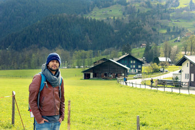 Full length of woman standing on landscape against mountains