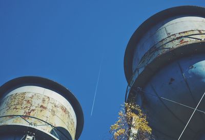 Low angle view of water towers against blue sky at caumsett state historic park