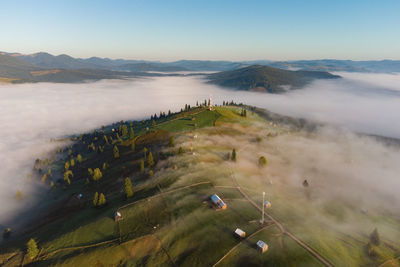 Mountain landscape with morning fog, at the forest edge, in bukovina, romania