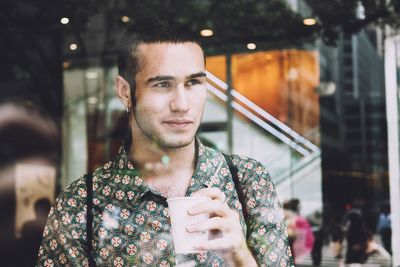 Portrait of young man drinking coffee