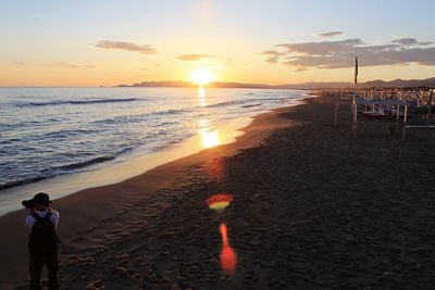 Scenic view of beach against sky during sunset