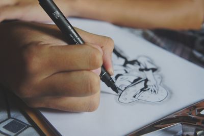 Close-up of hand holding paper