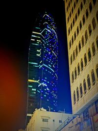 Low angle view of illuminated buildings at night