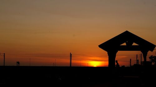 Silhouette building against sky during sunset