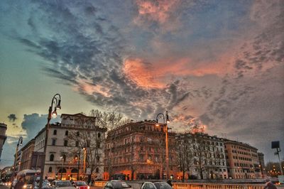 Carousel in amusement park against dramatic sky