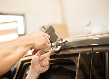 Close-up of hands holding tool