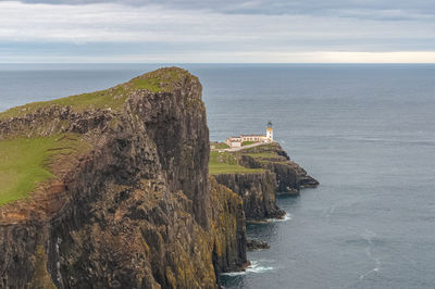 Cliffs with the neist point lighthouse in the background, isle of skye, scotland