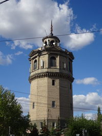Low angle view of building against cloudy sky