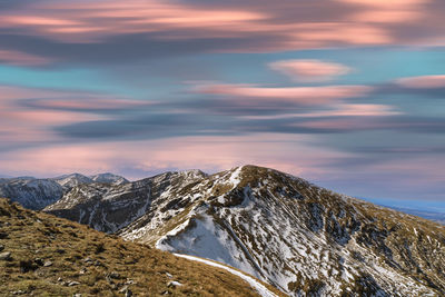 Scenic view of snowcapped mountains against sky