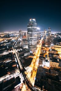 High angle view of illuminated buildings against sky at night