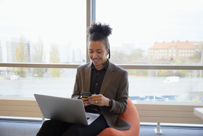 Man in office using cell phone