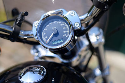 Close-up of motorcycle on sunny day