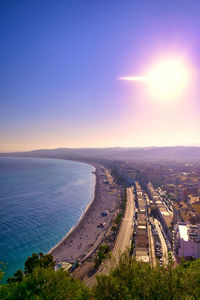 High angle view of city by sea against sky