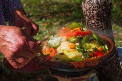 Cropped hand making food