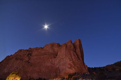 Low angle view of rock against sky at night