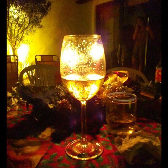 indoors, table, illuminated, glass - material, food and drink, candle, drinking glass, wineglass, transfer print, restaurant, drink, burning, flame, transparent, wine, refreshment, fire - natural phenomenon, night, close-up, alcohol