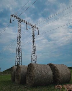 Low angle view of electricity pylon against sky