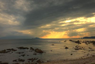 Scenic view of sea against cloudy sky