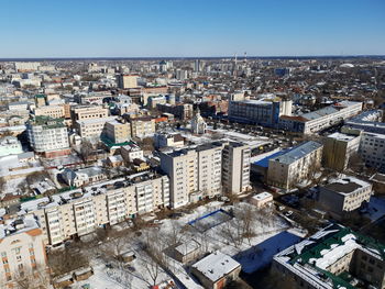 High angle view of buildings in city against clear sky