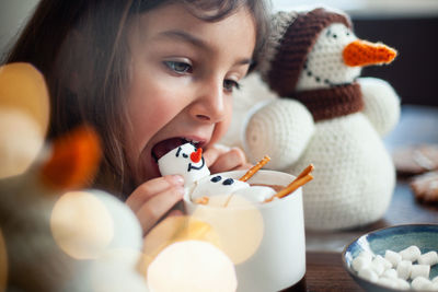 Close-up portrait of girl with toy