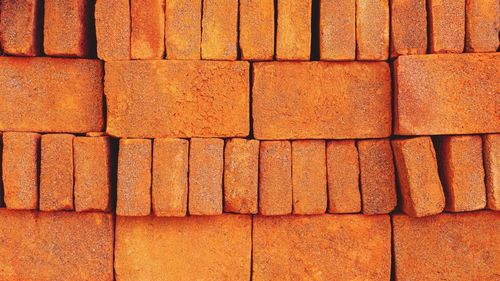 Full frame shot of beautiful red bricks stacks in different layouts to form a pattern