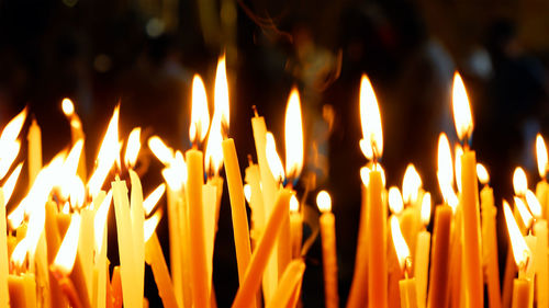 Close-up of lit candles in temple