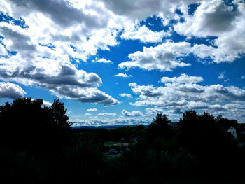 Silhouette trees on landscape against sky