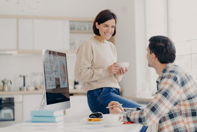 Woman working with mobile phone in office