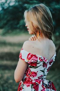 Side view of woman wearing dress standing outdoors