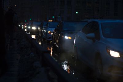 Cars in illuminated city at night