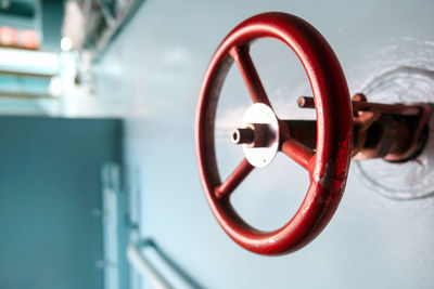 Close-up of faucet control on wall