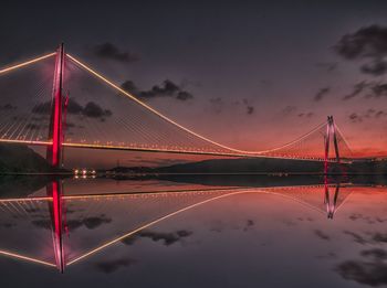 Low angle view of illuminated bridge against sky during sunset