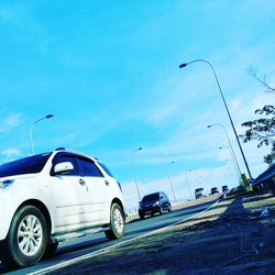 Cars on road against sky