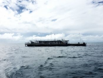 Ship sailing on sea against sky